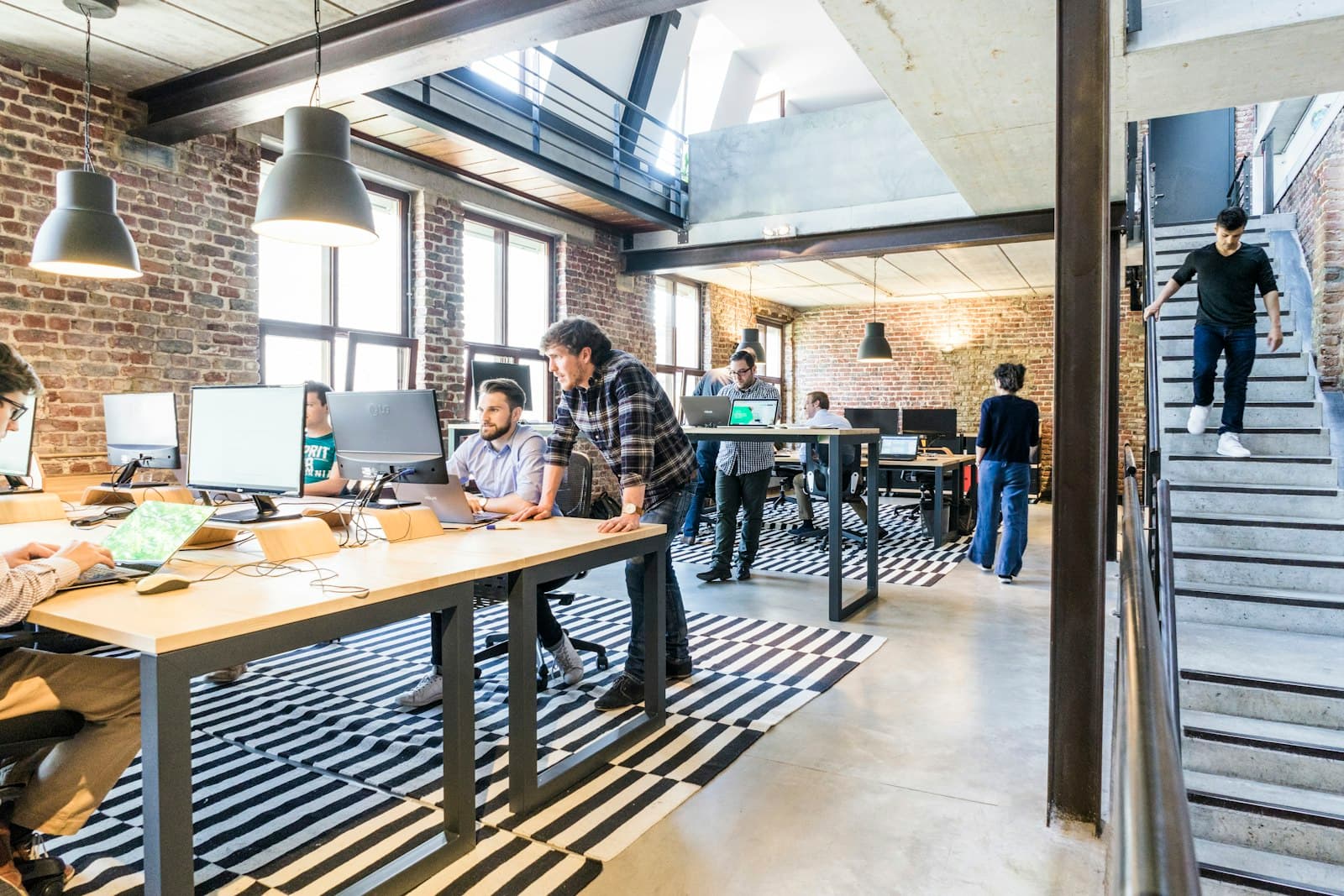 Developers and a designer working together in an open-plan office