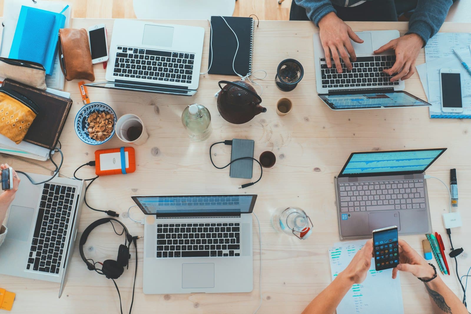 Developers working on laptops in a Pakistani software office