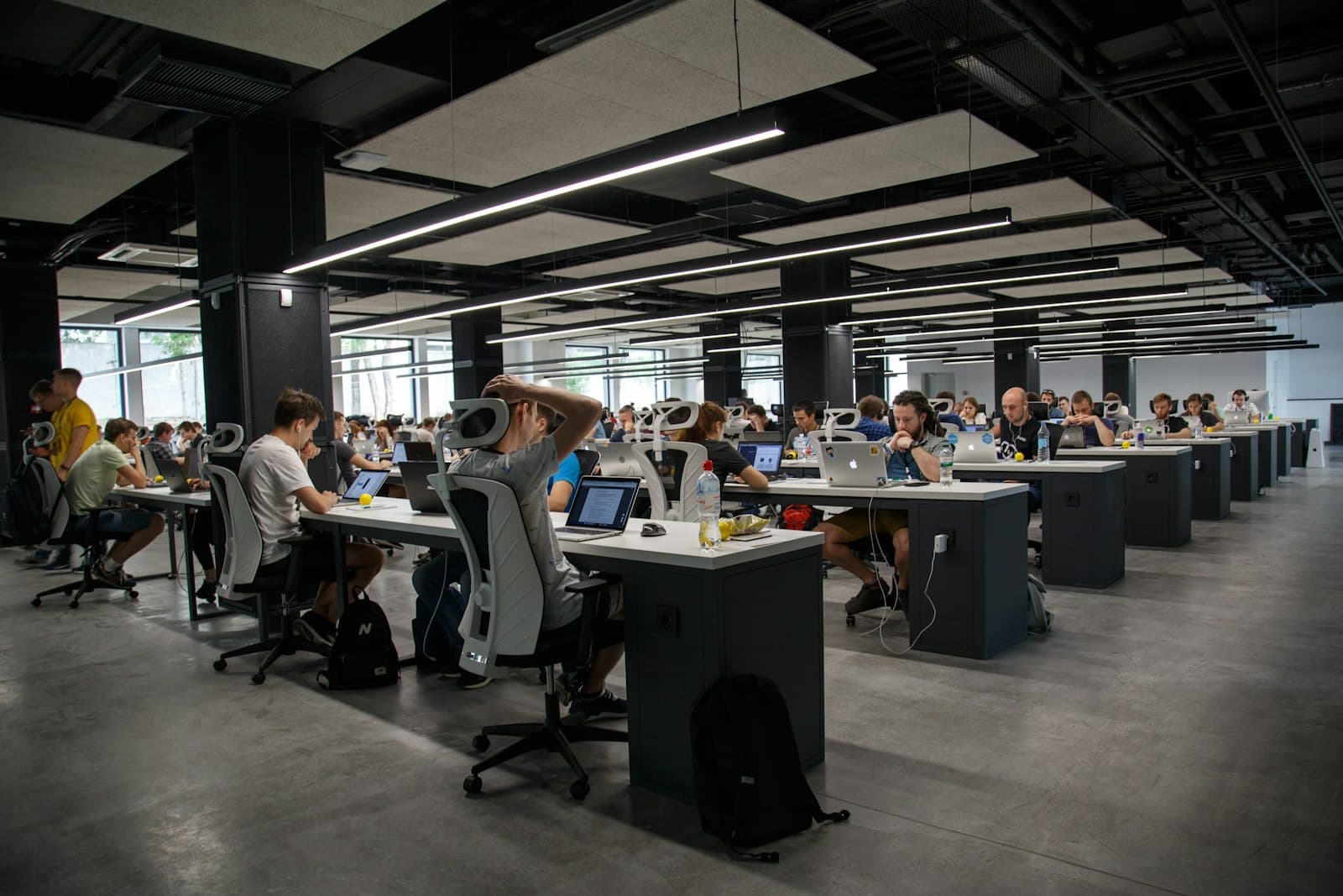 Engineering team working at rows of desks in an open-plan office