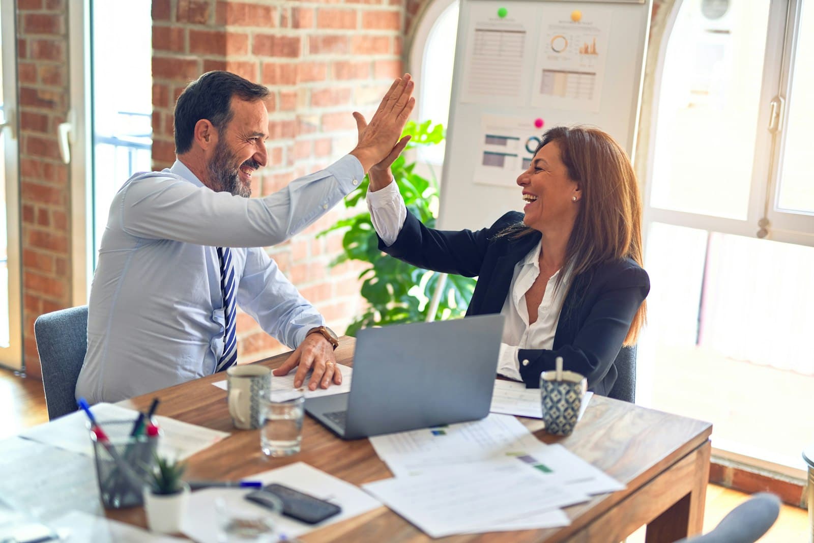 Two people shaking hands after agreeing a deal